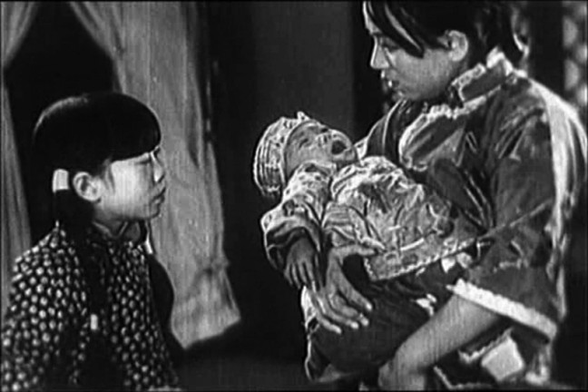 Actor Wang Renmei (with infant) in The Song of the Fishermen, playing at the SF Silent Film Festival on May 30.